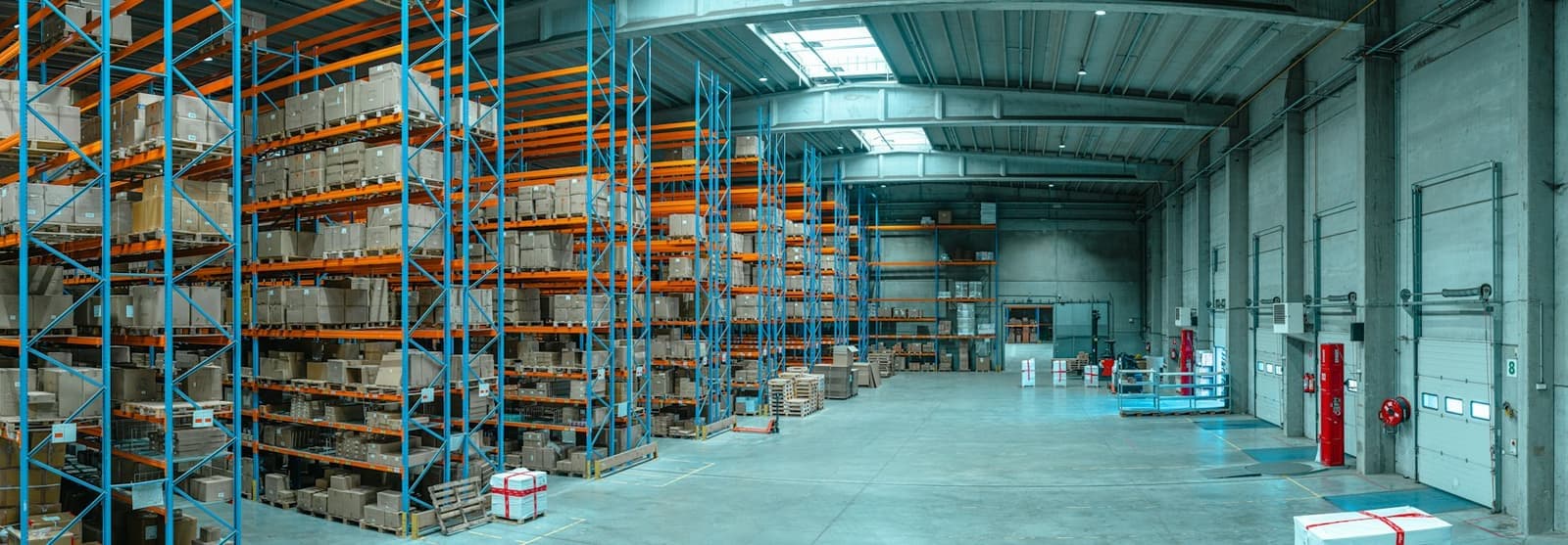 Tall blue shelving filled with cardboard boxes in a warehouse