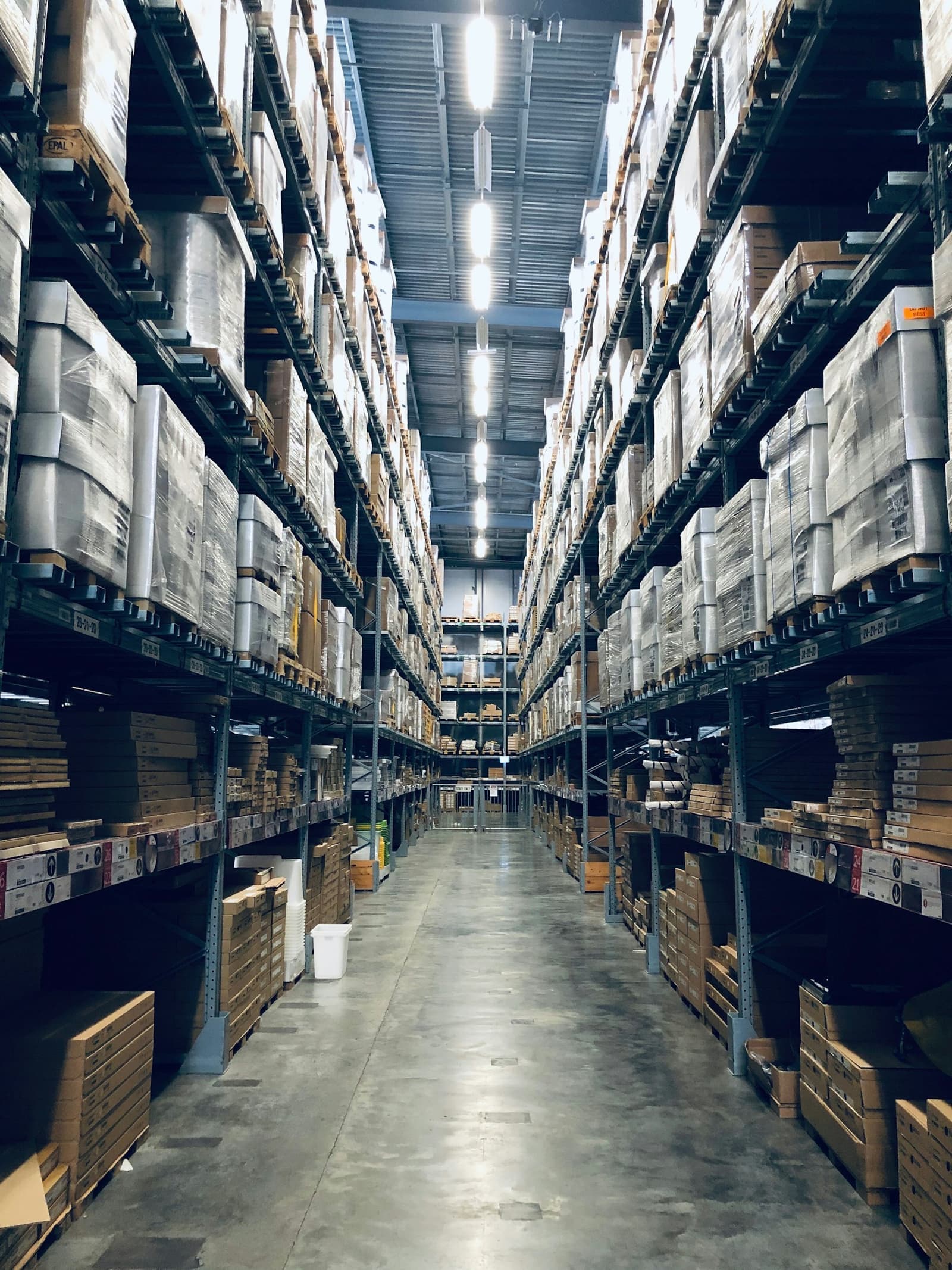 Forklift moving pallets through a busy warehouse